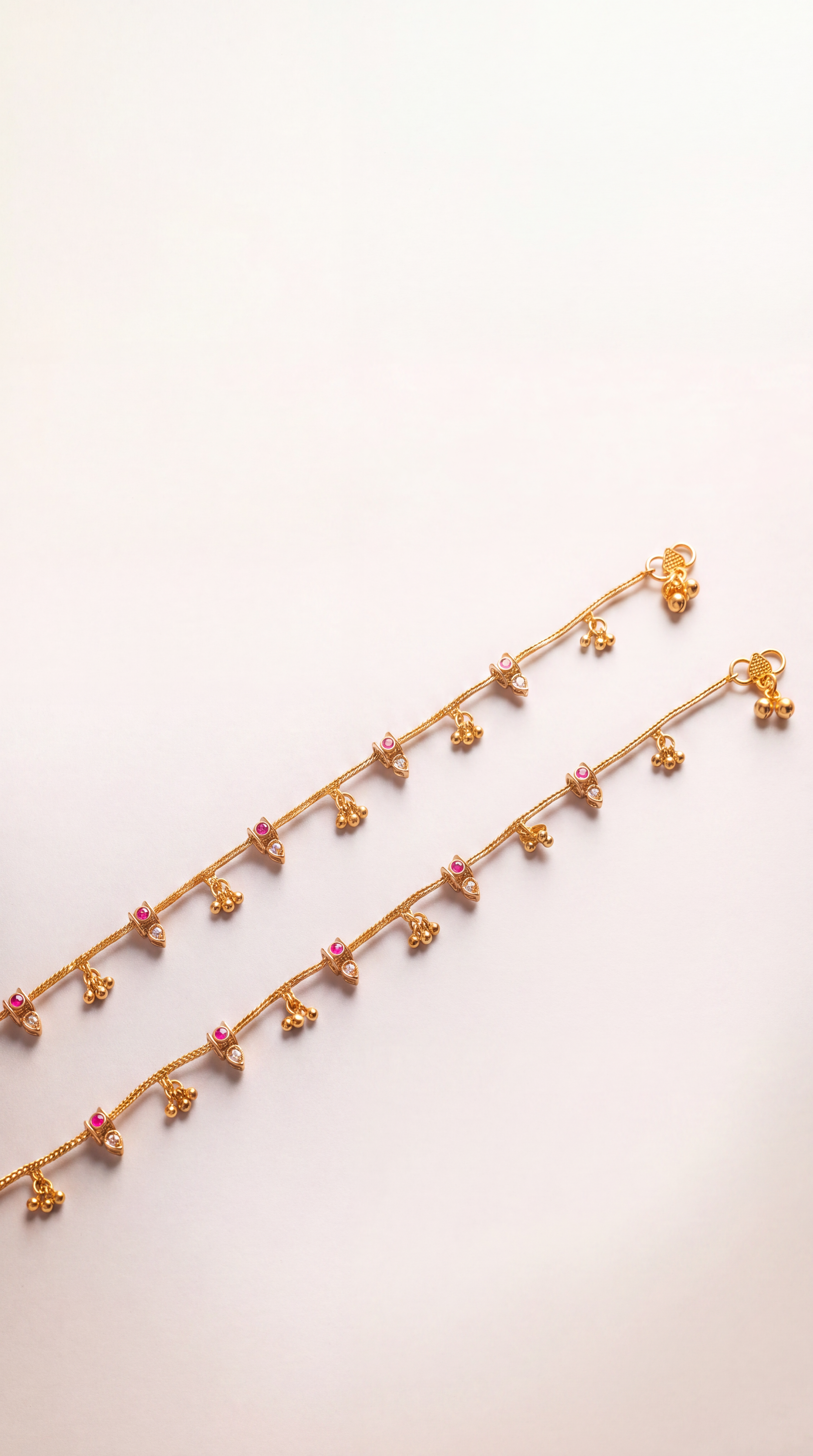 Mira Dewdrop Anklets clasp detail, gold-tone chain with tiny bells, clear pear stones, and pink accents