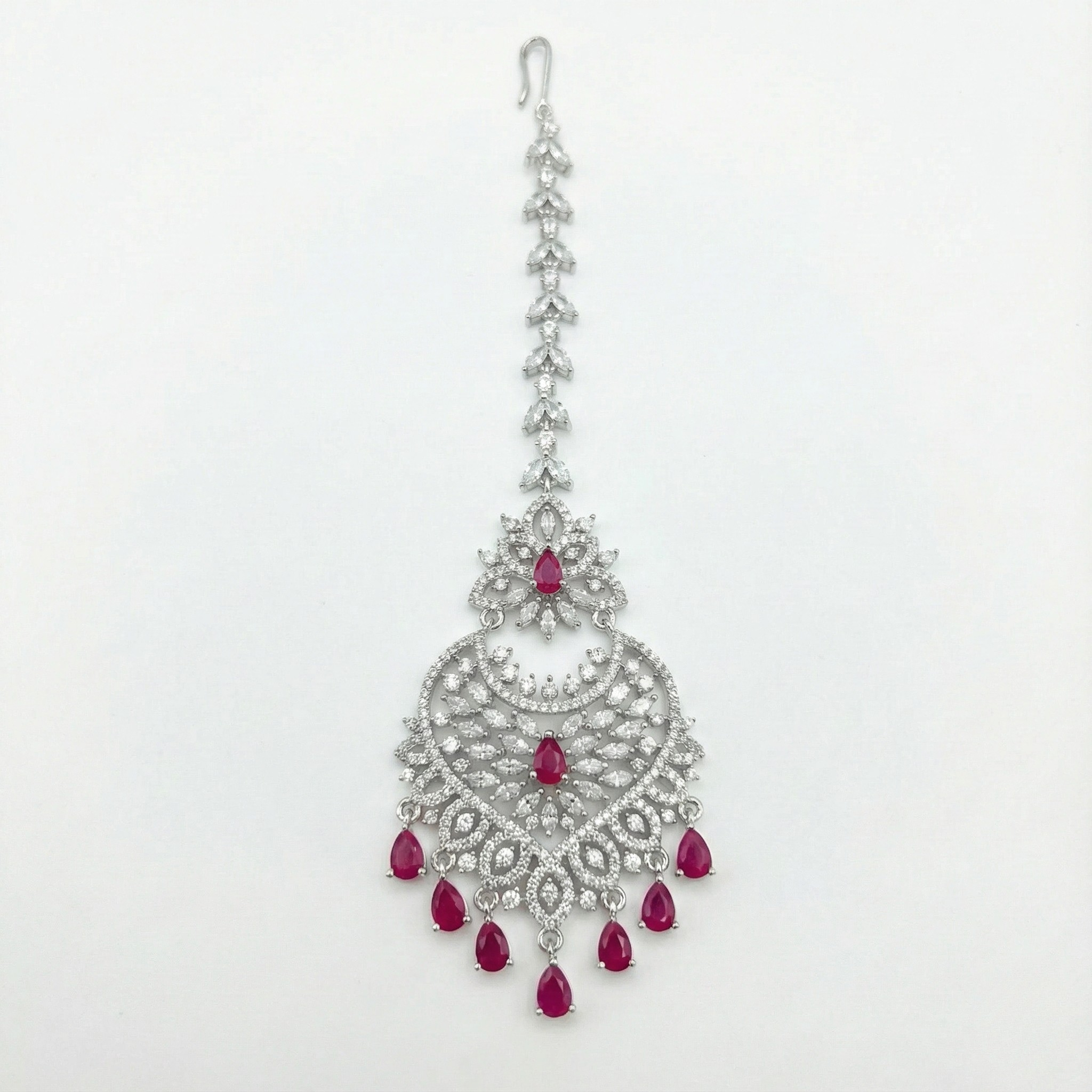 Moonfall Ruby Tikka silver-tone heart pendant maang tikka with red teardrop drops on gray background