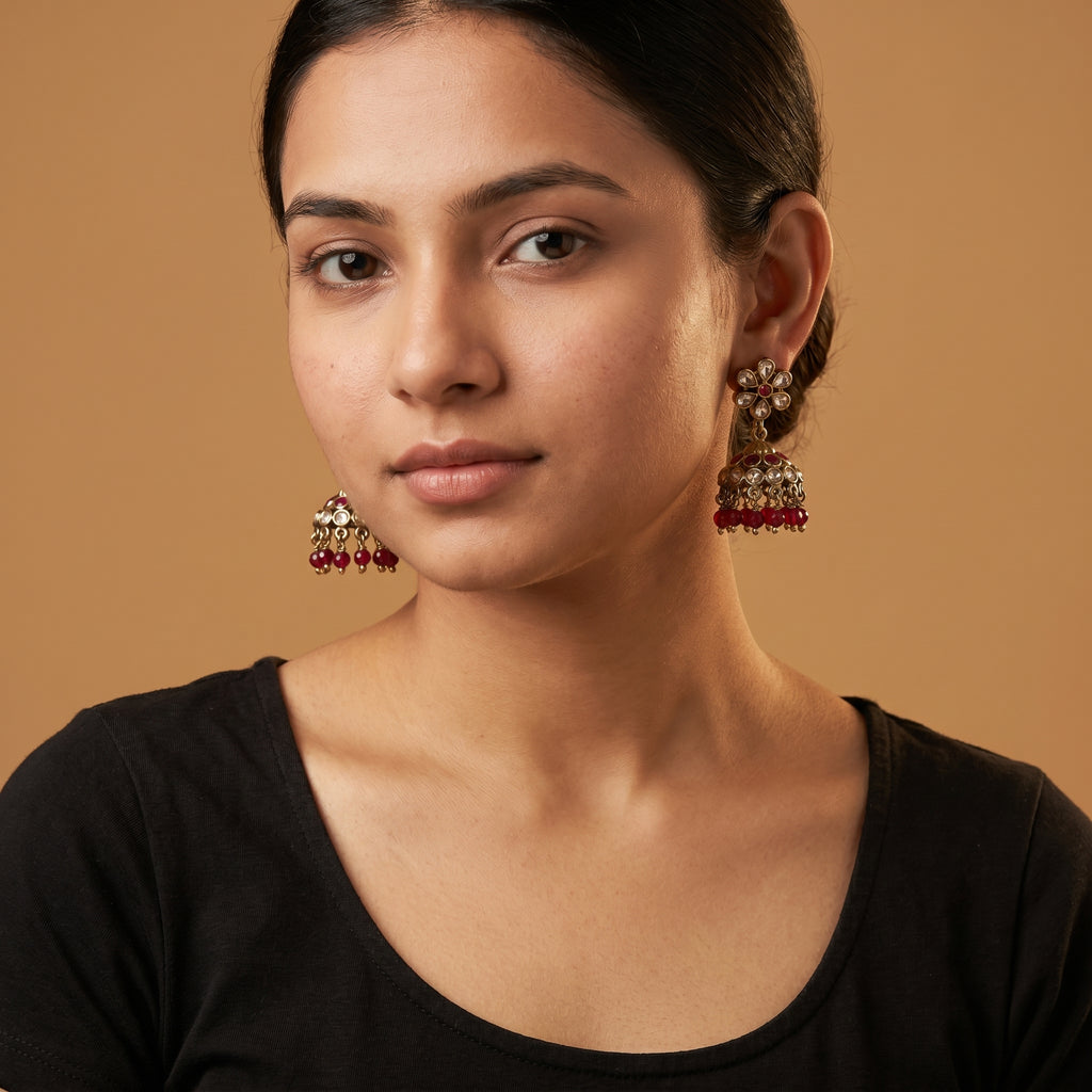 Amrita Ruby Earrings detail showing floral polki stud and ruby bead fringe on the bell