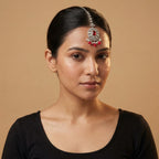 Ruby Bloom Tikka detail showing clear crystal chain, red center medallion, and dangling red beads
