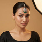 Noor Emerald Tikka detail showing clear crystal chain, pavé circle, and emerald-green drop beads
