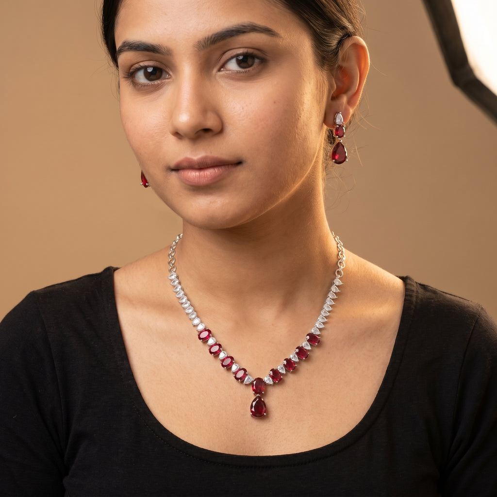 Rani Ruby Necklace Set detail of graduated ruby stones and clear teardrop accent border