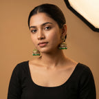 Mayuri Moti Earrings detail showing peacock top filigree dome and emerald pearl dangle fringe