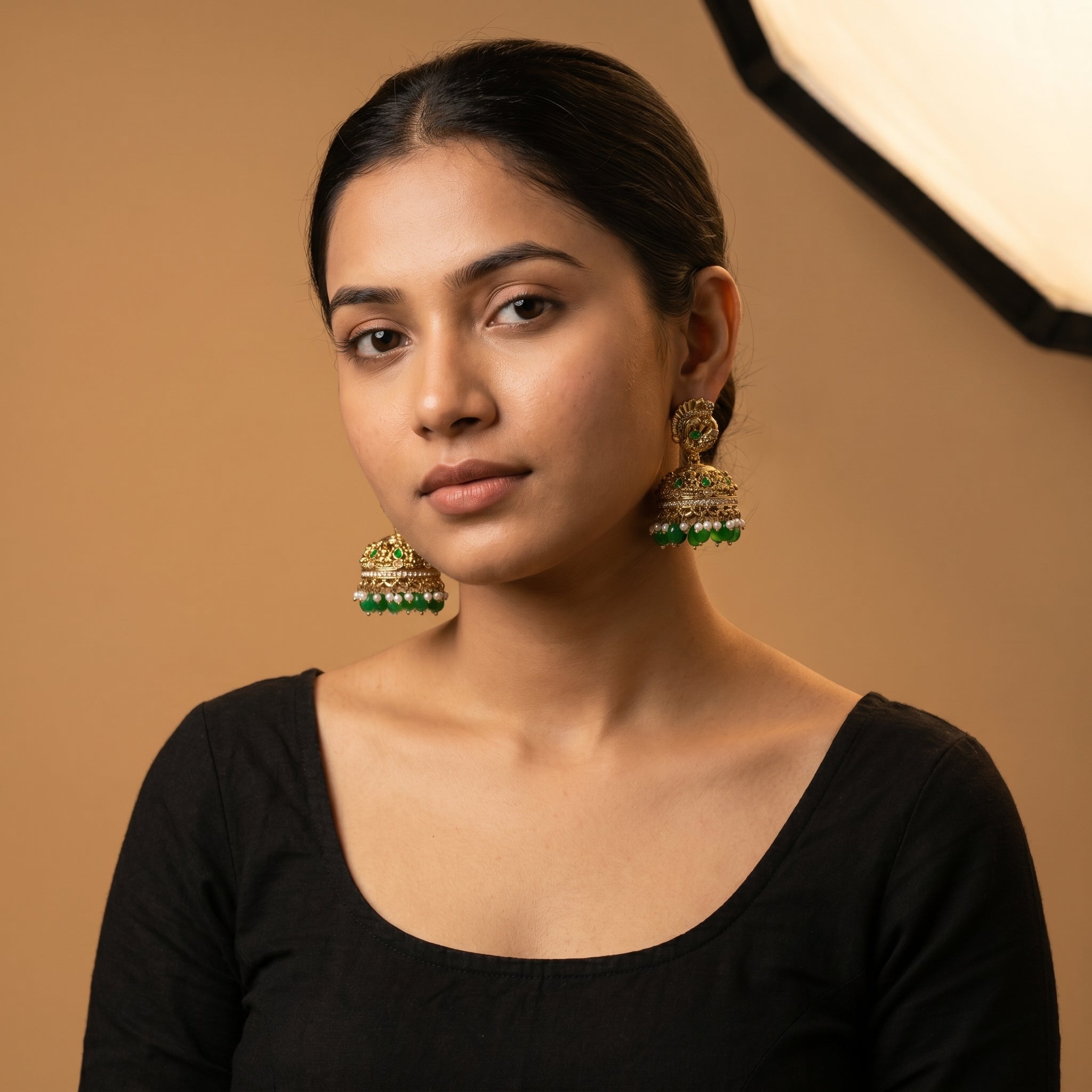 Mayuri Moti Earrings detail showing peacock top filigree dome and emerald pearl dangle fringe
