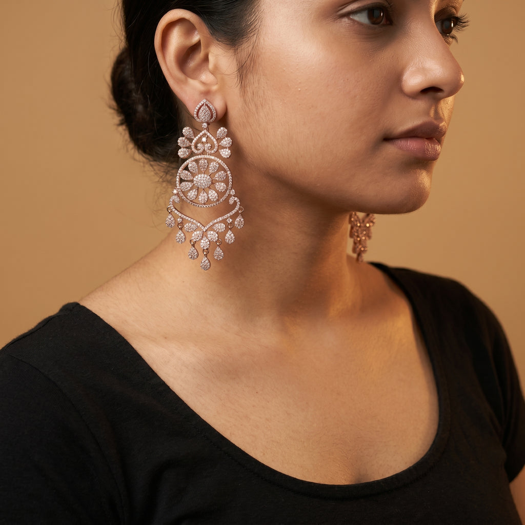 Roshni Earrings detail showing sunburst floral center, heart filigree tiers, and pavé crystal dangles