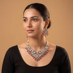 Aira Ruby Necklace Set detail showing clear polki filigree and ruby-red teardrop bead fringe
