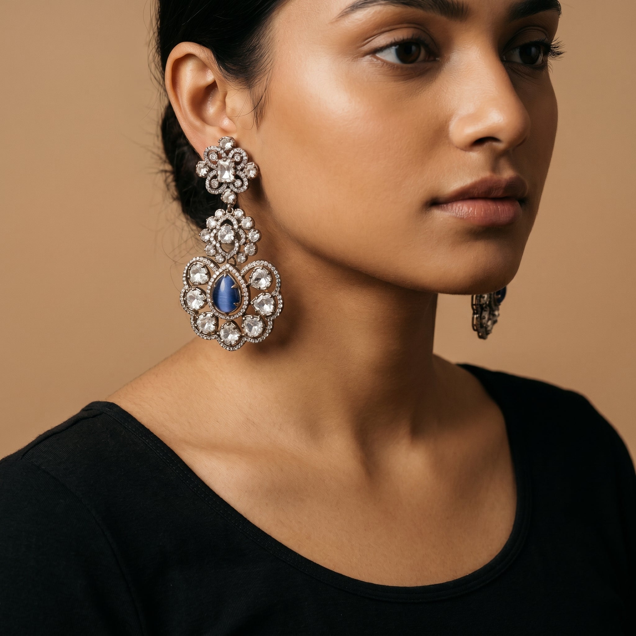 Neelam Bloom Earrings detail showing midnight blue cat's eye center, rose-cut crystal petals, and floral pavé halo