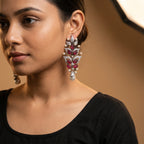 Rani Ruby Earrings detail showing carved ruby-red leaves, clear crystal foliage, and teardrop pearl drop