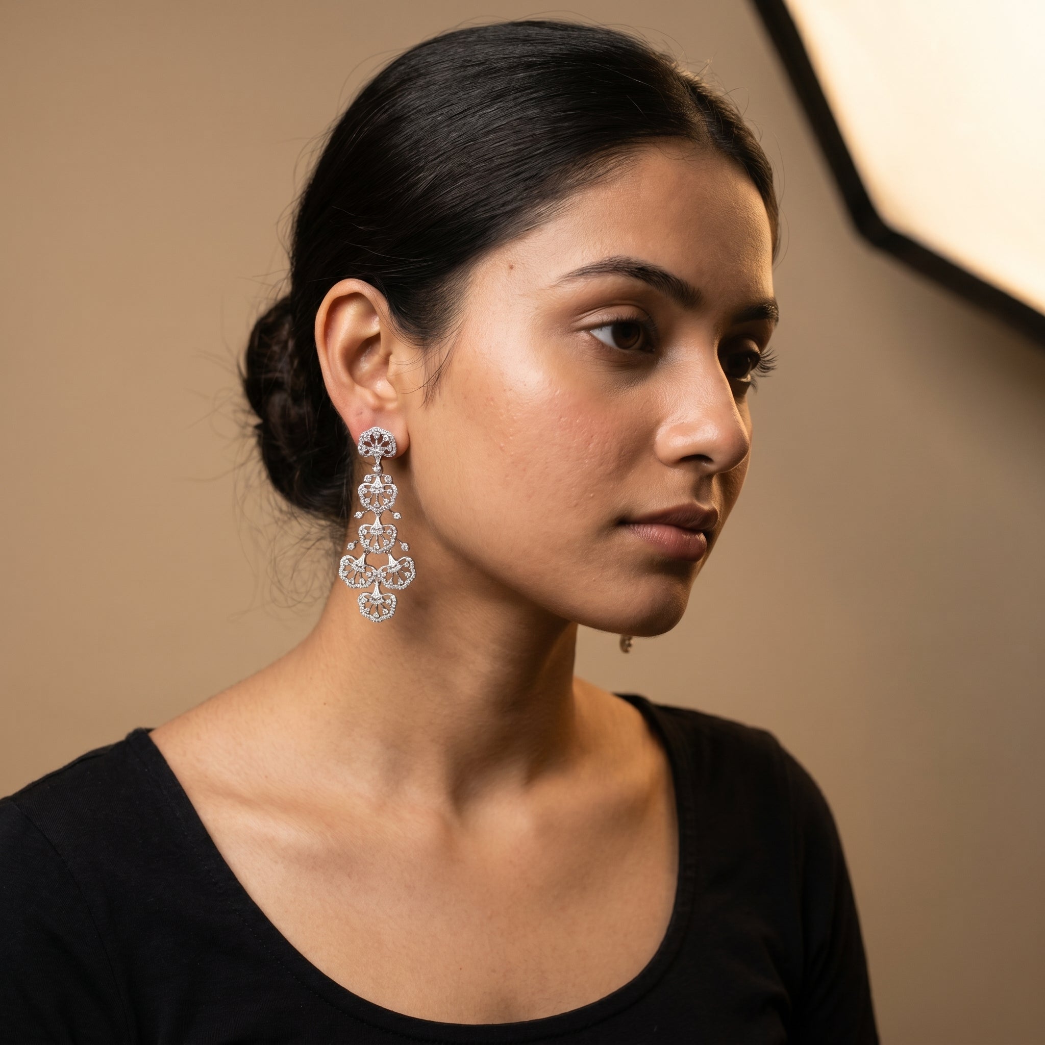 Noor Cascade Earrings detail showing scalloped fan tiers and radiating clear stone spokes
