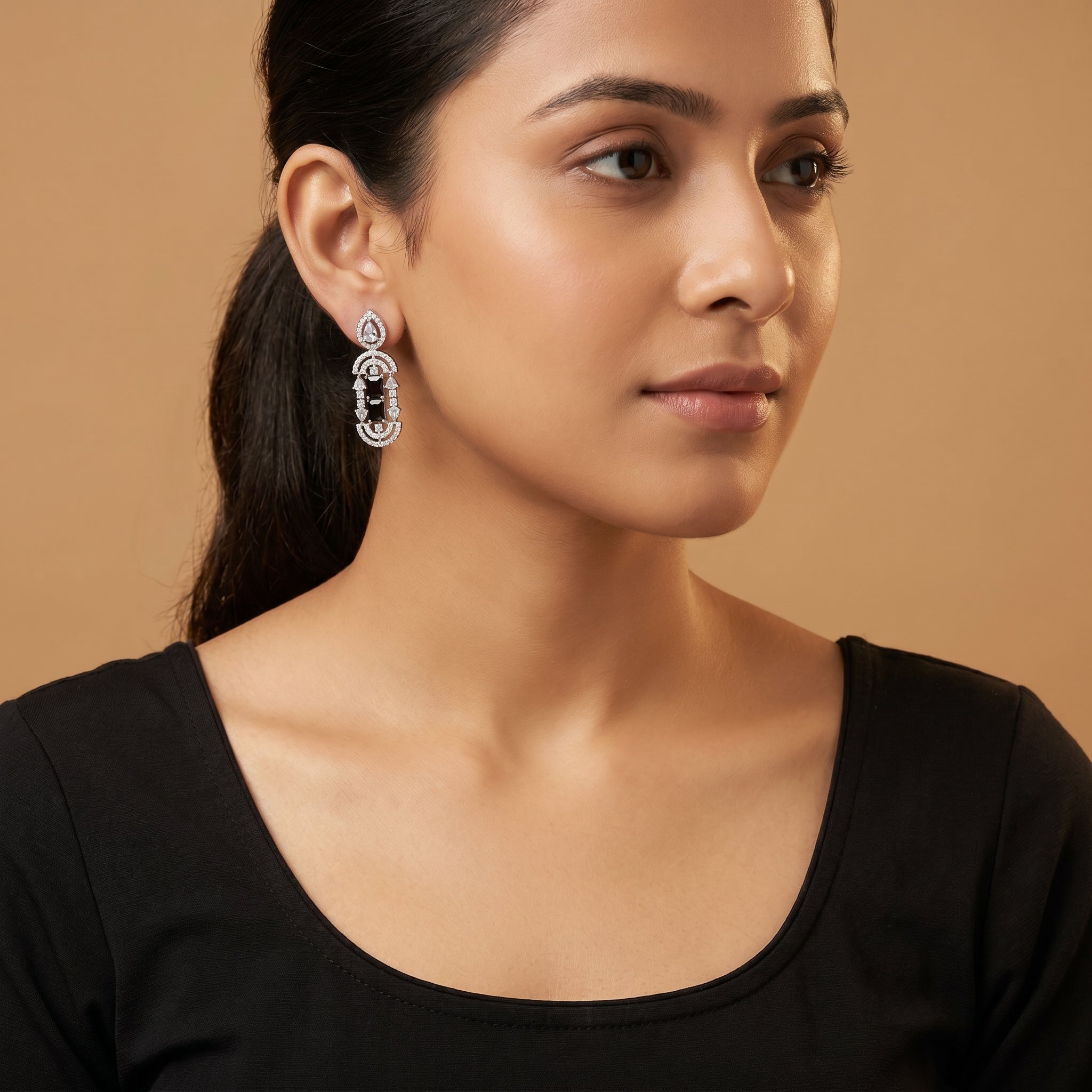 Aira Onyx Earrings detail showing stacked onyx center, pavé arches, and pear crystal accents