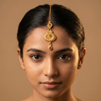 Priya Ruby Tikka detail showing filigree floral connector and ridged fan pendant with teardrop drop