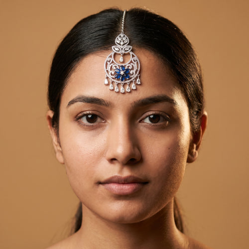 Adah Sapphire Tikka detail showing filigree round frame, blue stone flower, and crystal fringe
