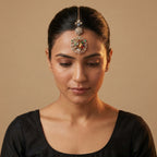 Navrang Tikka detail showing stacked medallions and oxidized gold scrollwork with colored stones