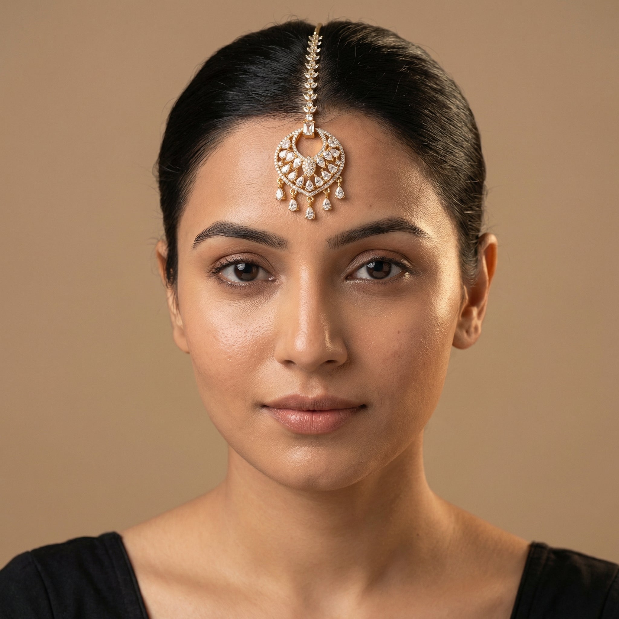 Amala Zircon Tikka detail showing emerald-cut connector, pavé medallion, and five pear crystal dangles