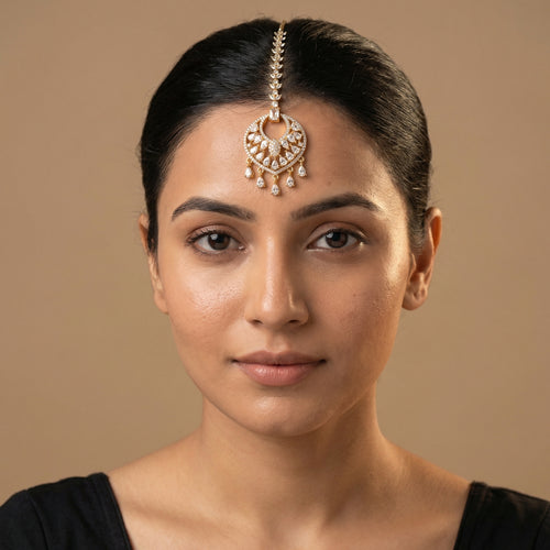 Amala Zircon Tikka detail showing emerald-cut connector, pavé medallion, and five pear crystal dangles