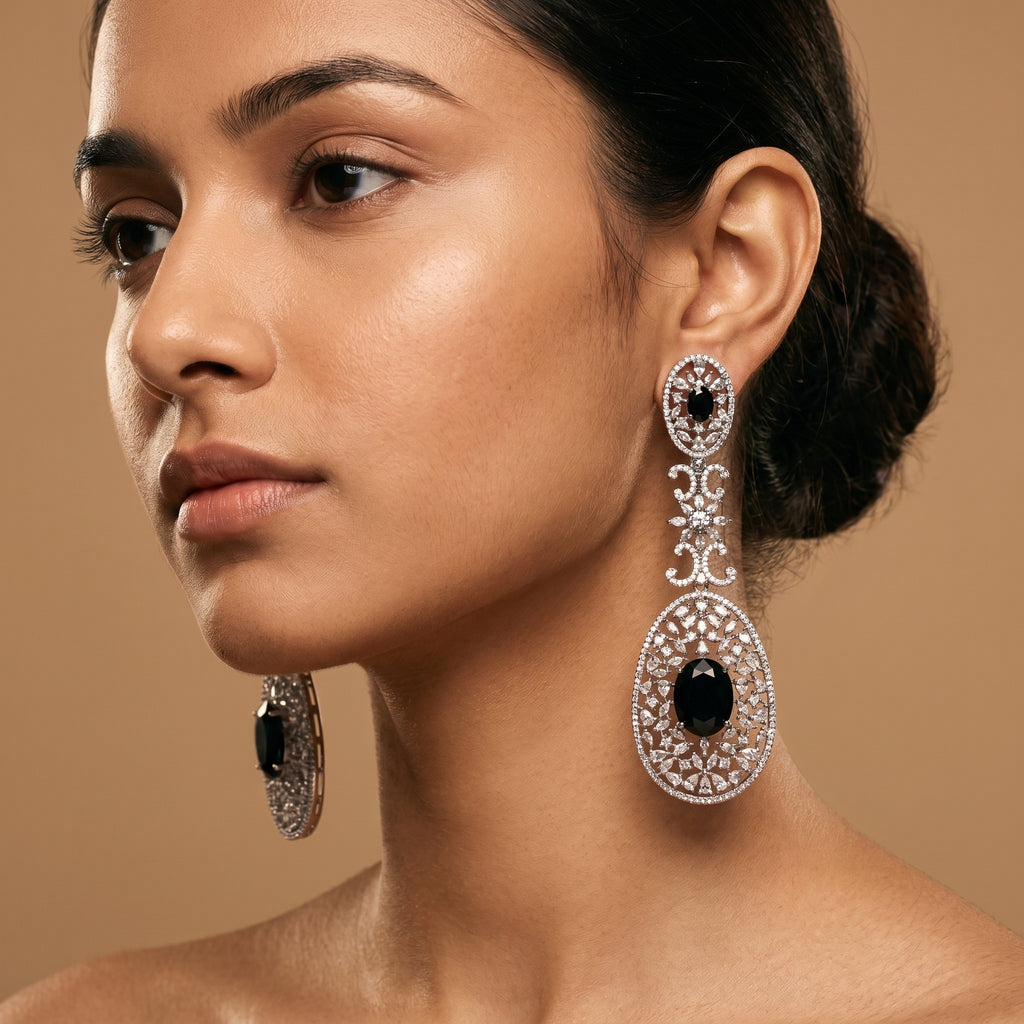 Zara Onyx Earrings detail showing oval black onyx stones, marquise crystal floral link, and pavé lace filigree