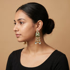 Kiara Emerald Earrings detail showing emerald enamel plaque and cascading teardrop stone tiers