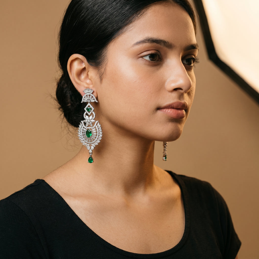 Divya Emerald Earrings detail showing baguette fan top sunburst medallion and green pear drop