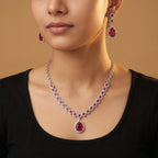 Aira Ruby Necklace Set detail showing halo-set round rubies and pear-cut drop pendant