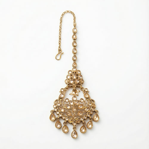 Antique Golden Tikka antique gold chandelier maang tikka with champagne crystals and teardrop dangles on gray background