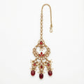 Chandrika Ruby Drop Tikka gold-tone kundan maang tikka with ruby drops and pearls on gray background