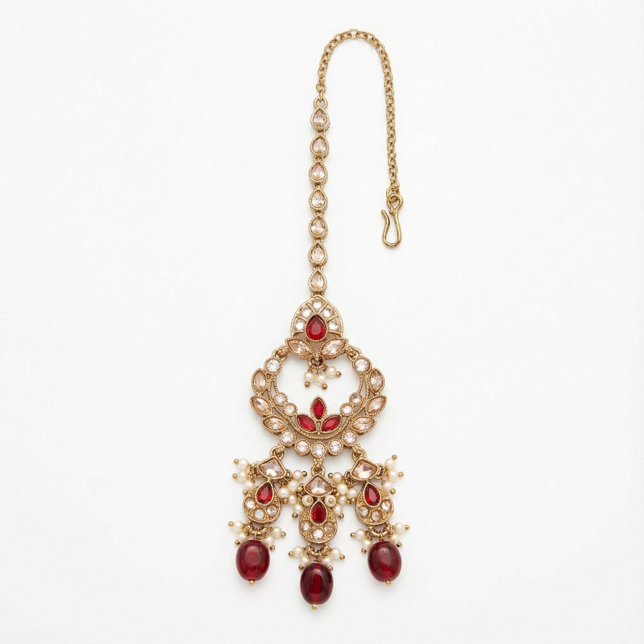 Chandrika Ruby Drop Tikka gold-tone kundan maang tikka with ruby drops and pearls on gray background