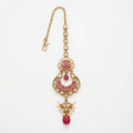 Zarrah Ruby Crescent Tikka gold crescent maang tikka with pink stones and pearl drops on white background