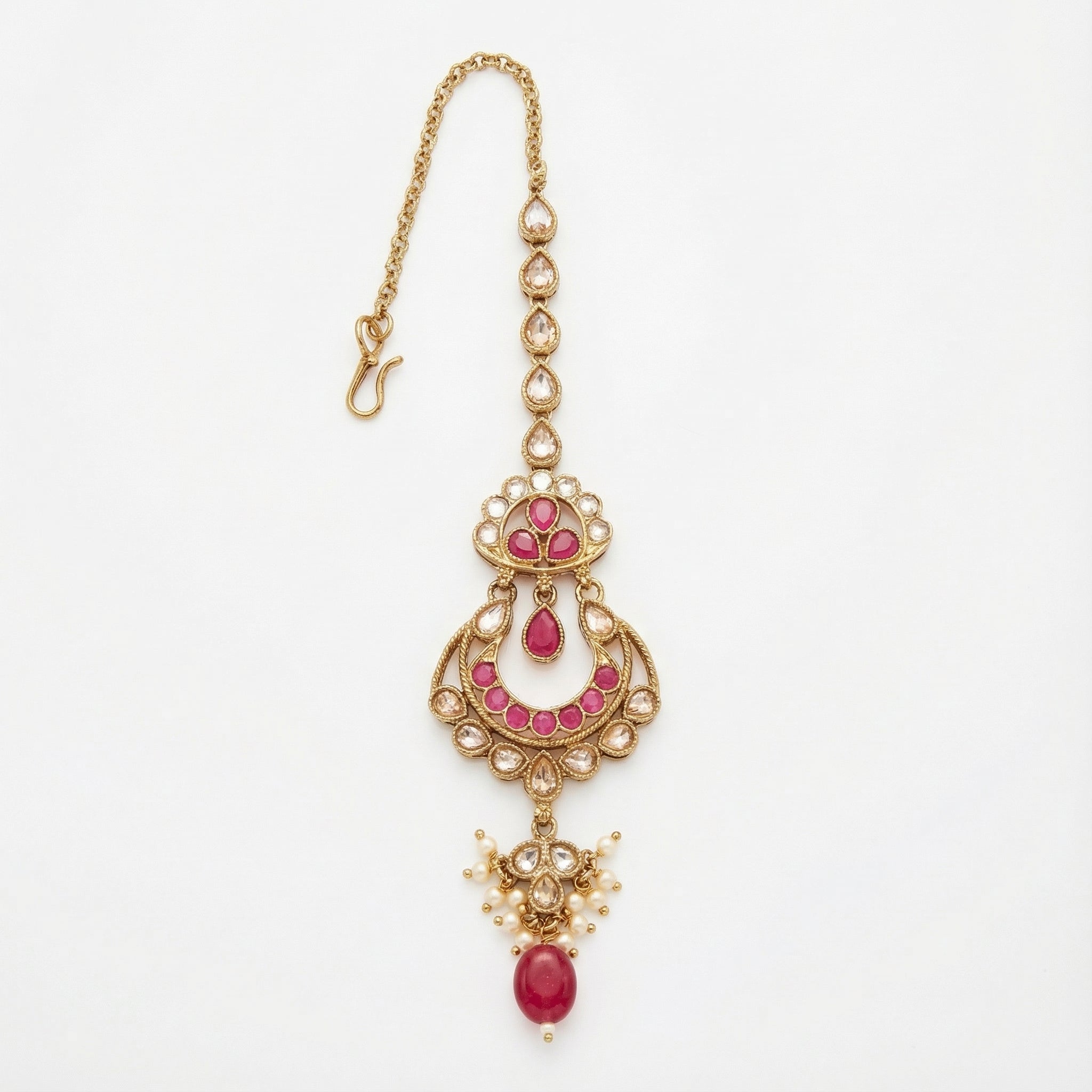 Zarrah Ruby Crescent Tikka gold crescent maang tikka with pink stones and pearl drops on white background
