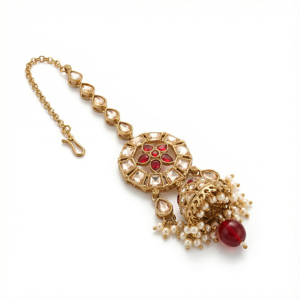 Ruby Jhumka Drop Tikka detail showing ruby floral center and bell jhumka pendant