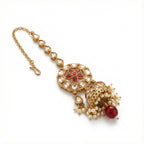 Ruby Jhumka Drop Tikka detail showing ruby floral center and bell jhumka pendant