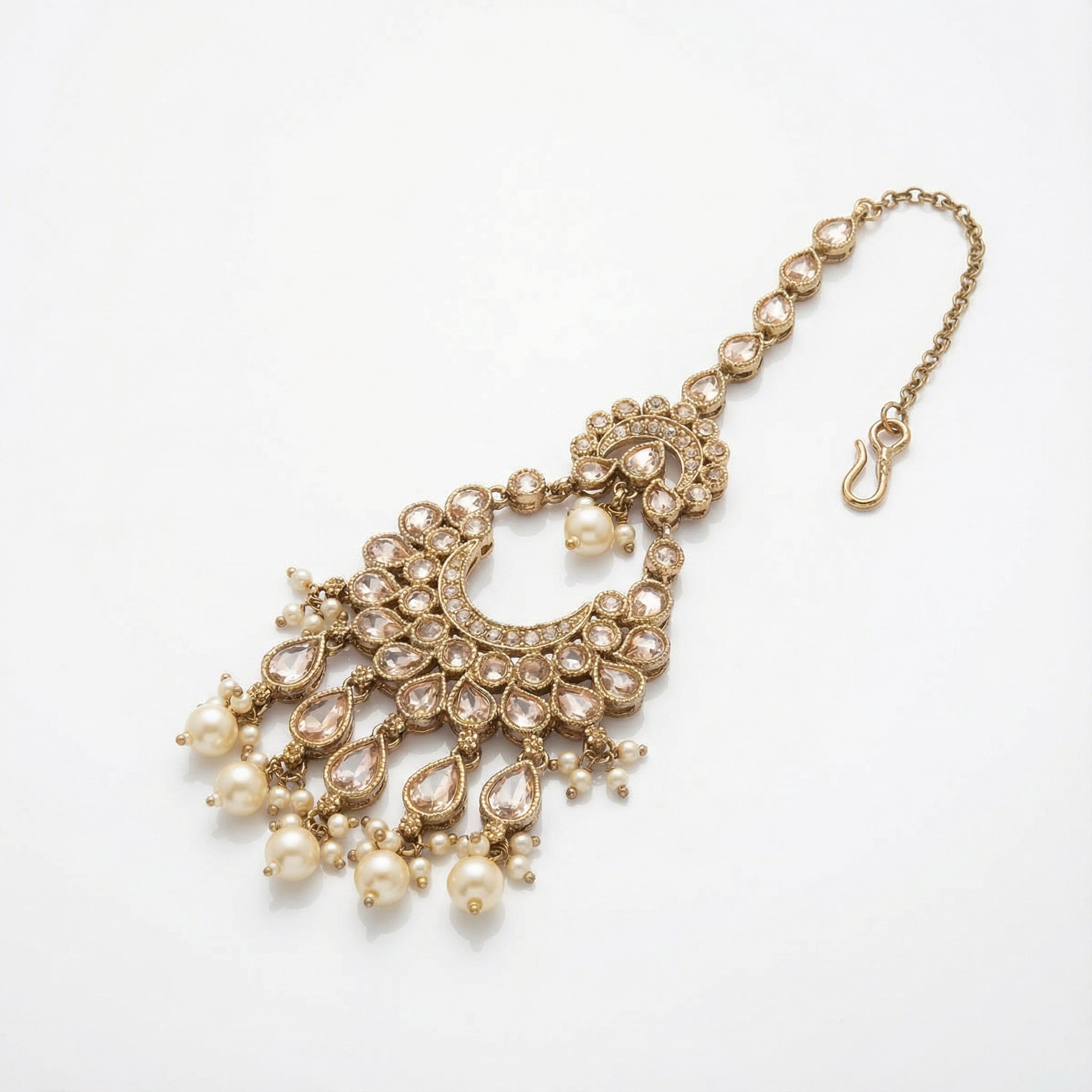 Ivory Heirloom Crescent Tikka detail showing pear-cut crystal chain, kundan crescent, and pearl fringe