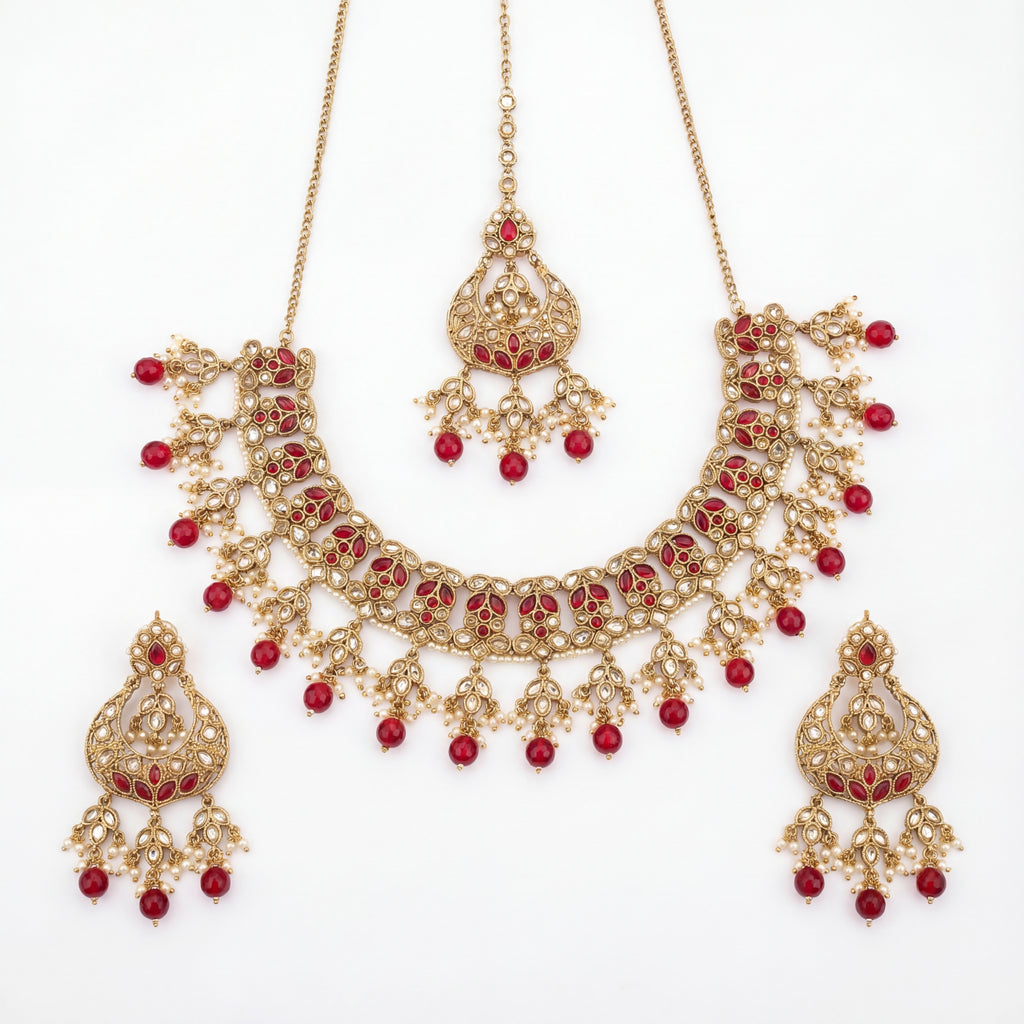 Studio flatlay of the ruby heirloom necklace set with matching earrings.