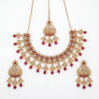 Studio flatlay of the ruby heirloom necklace set with matching earrings.