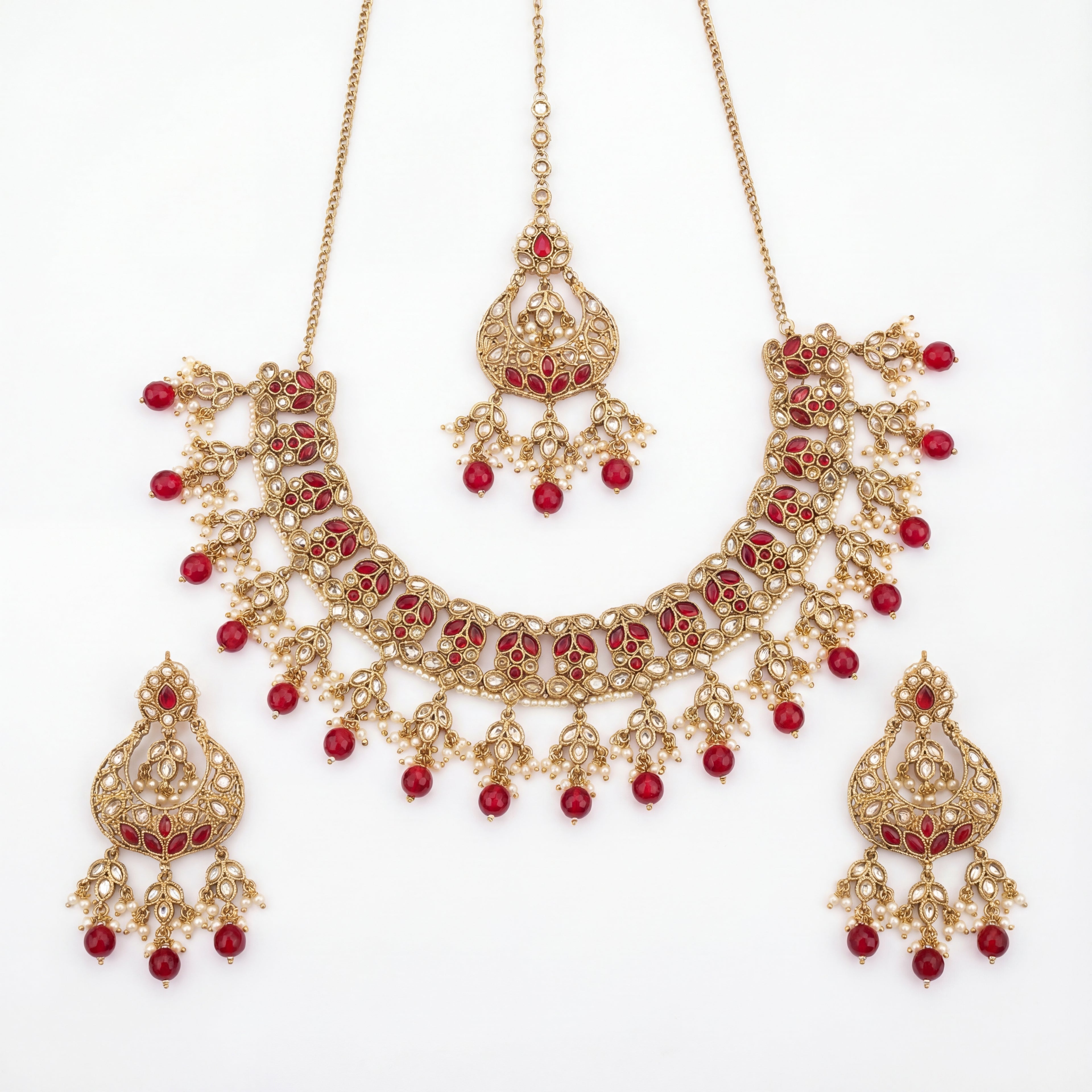 Studio flatlay of the ruby heirloom necklace set with matching earrings.