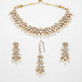 Sitara Pearl Polki Set gold choker with earrings and maang tikka on white background