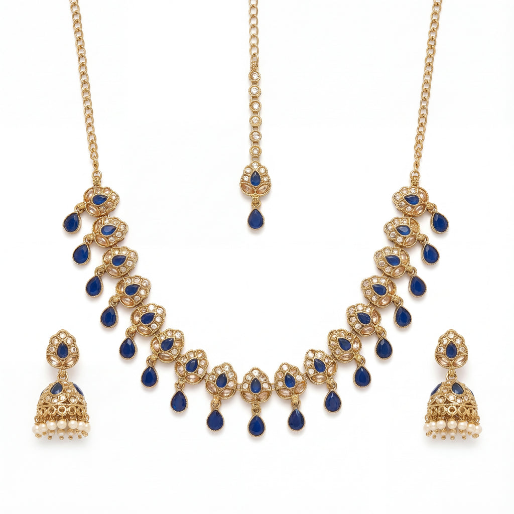 Studio flatlay of the gold-tone polki necklace with matching earrings