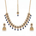 Studio flatlay of the gold-tone polki necklace with matching earrings