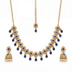 Studio flatlay of the gold-tone polki necklace with matching earrings