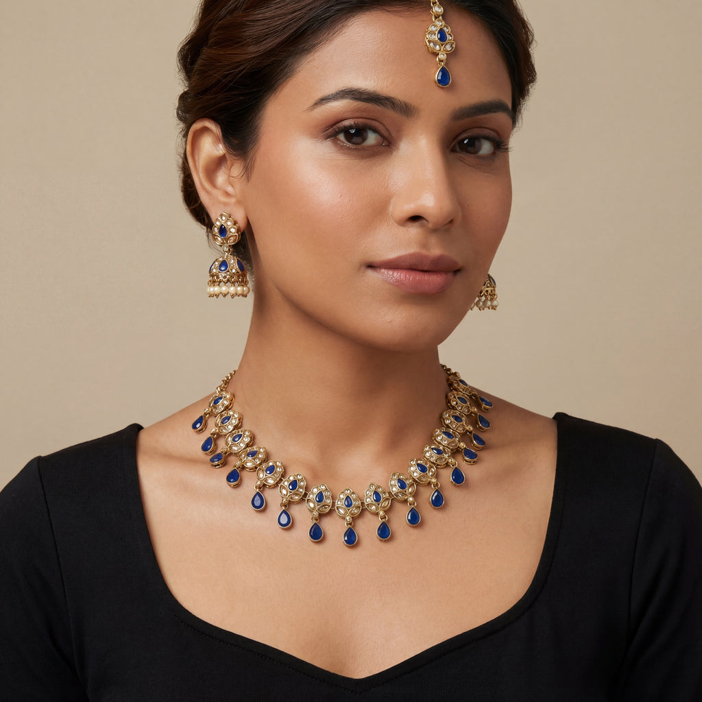 South Asian woman wearing the gold-tone polki necklace with matching earrings — bridal look