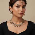 South Asian woman wearing the gold-tone polki necklace with matching earrings — bridal look