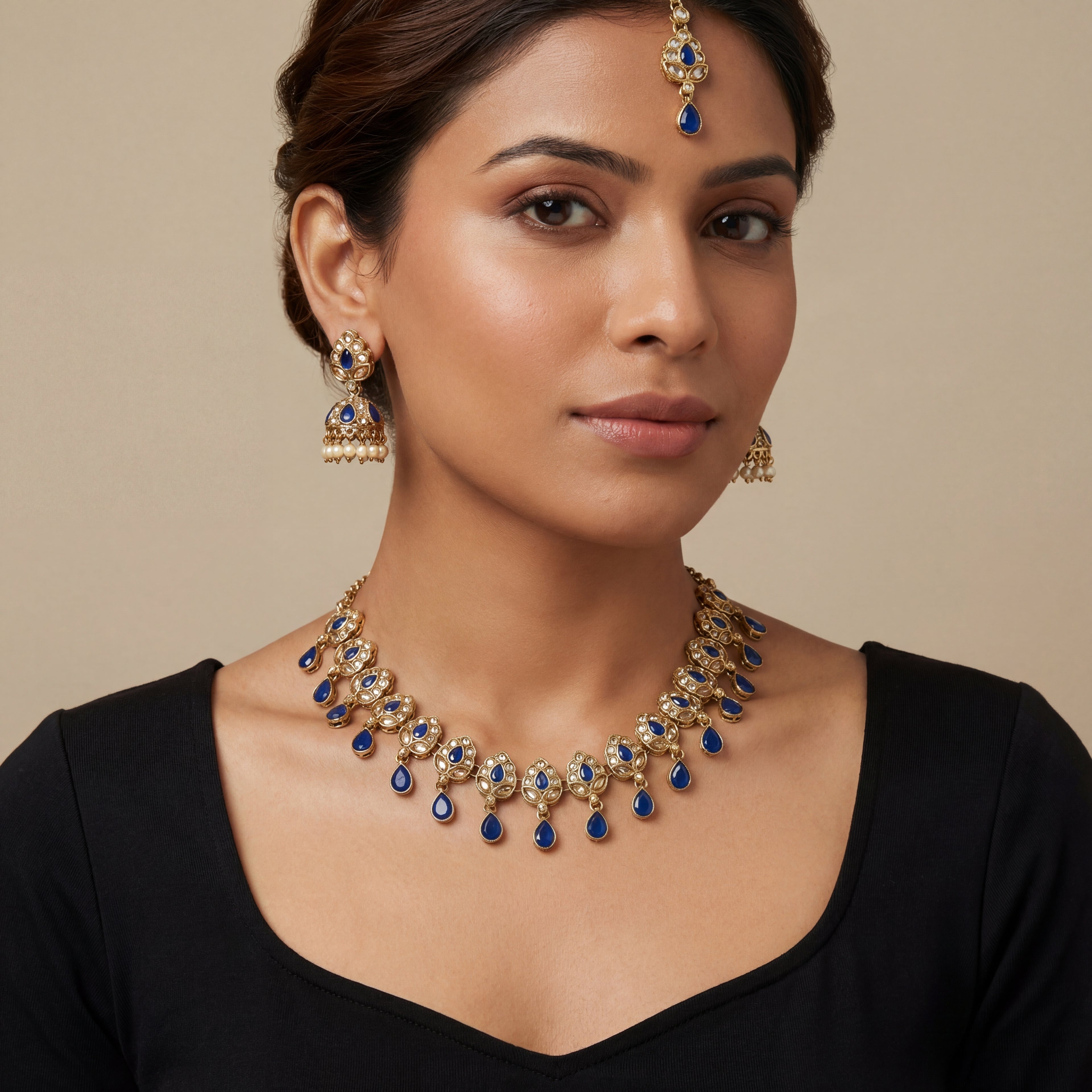 South Asian woman wearing the gold-tone polki necklace with matching earrings — bridal look