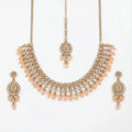 Studio flatlay of the gold-tone peach drop necklace with matching earrings