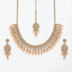 Studio flatlay of the gold-tone peach drop necklace with matching earrings