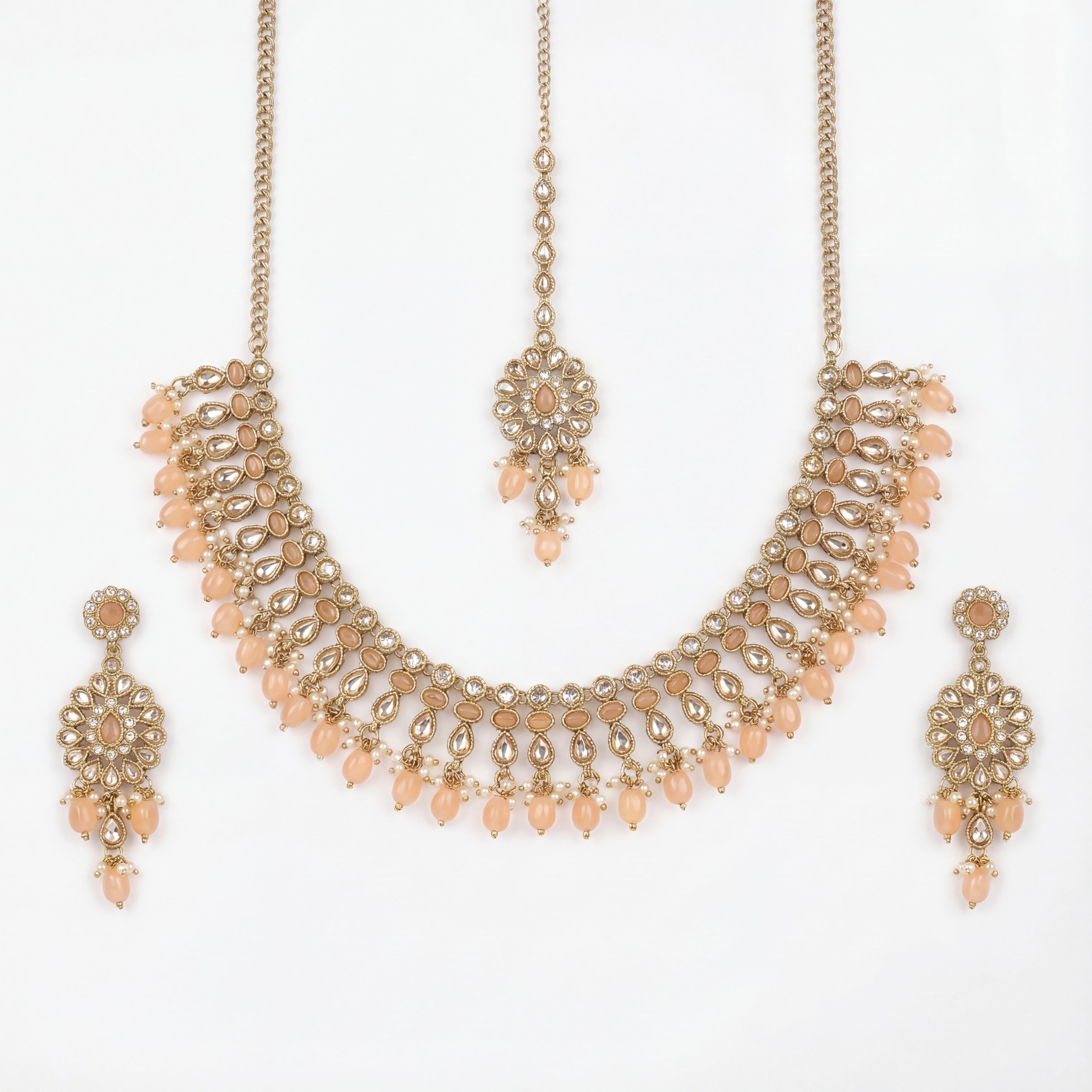Studio flatlay of the gold-tone peach drop necklace with matching earrings