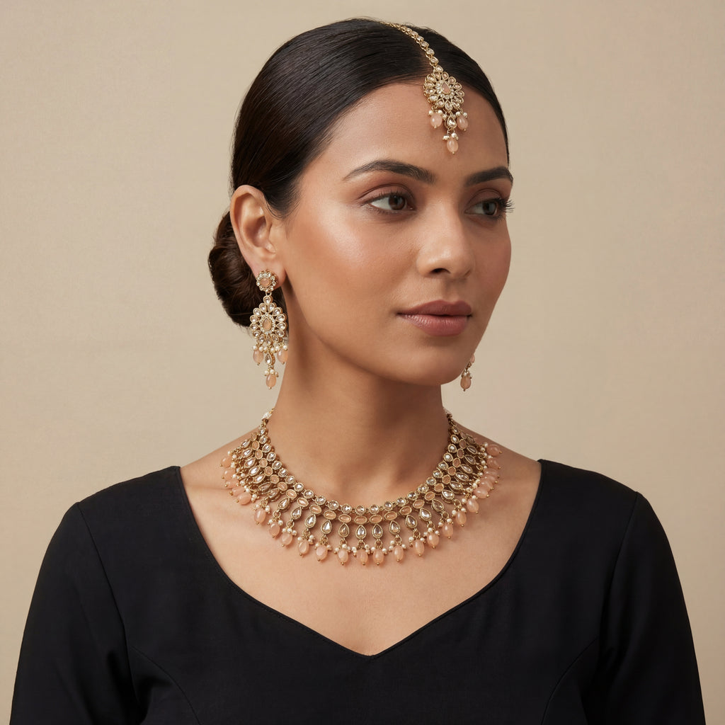 South Asian woman wearing the gold-tone peach drop necklace with matching earrings — bridal look