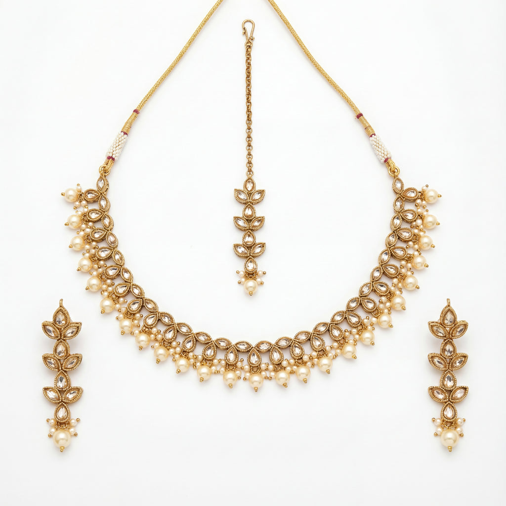 Studio flatlay of the ivory pearl necklace set with matching earrings.