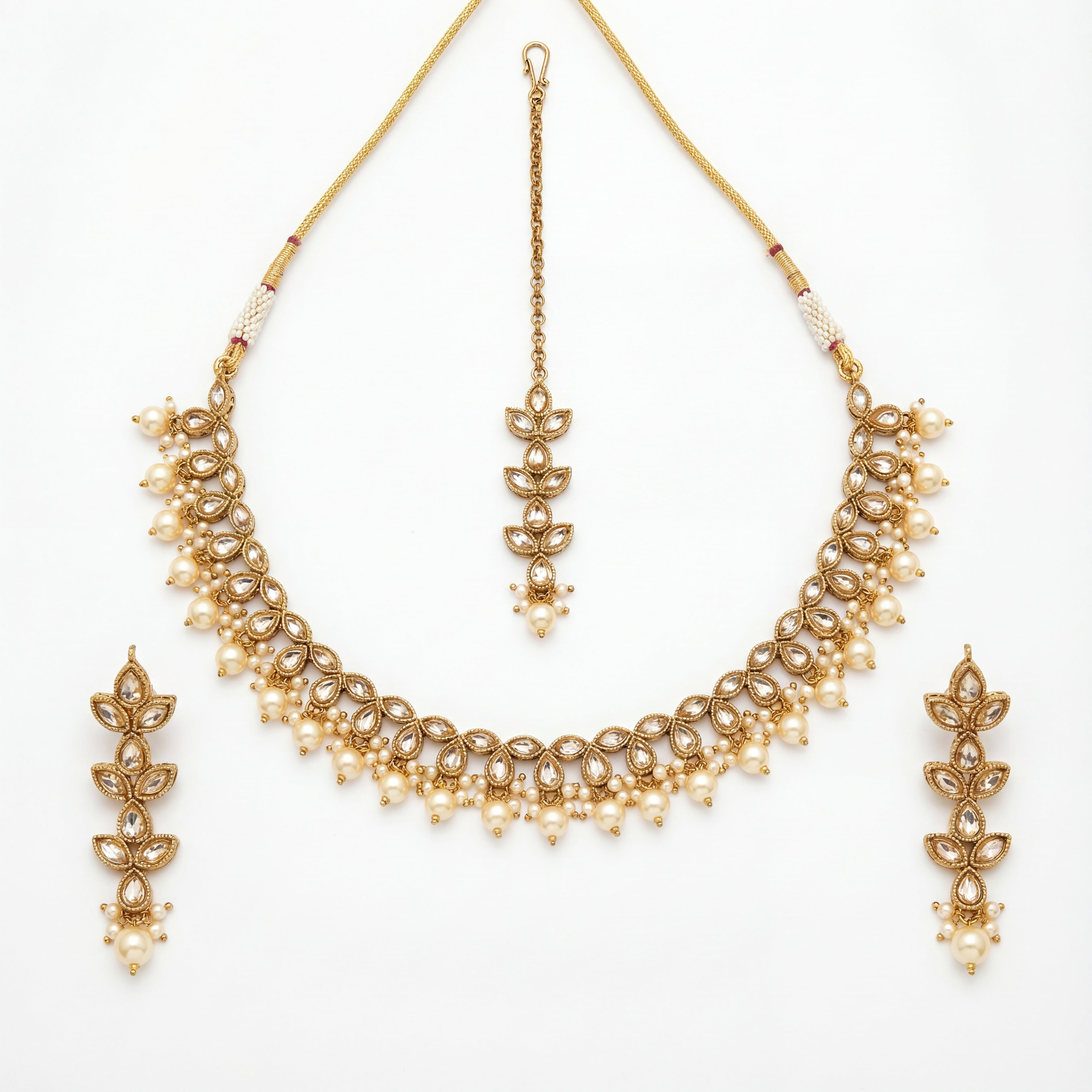 Studio flatlay of the ivory pearl necklace set with matching earrings.