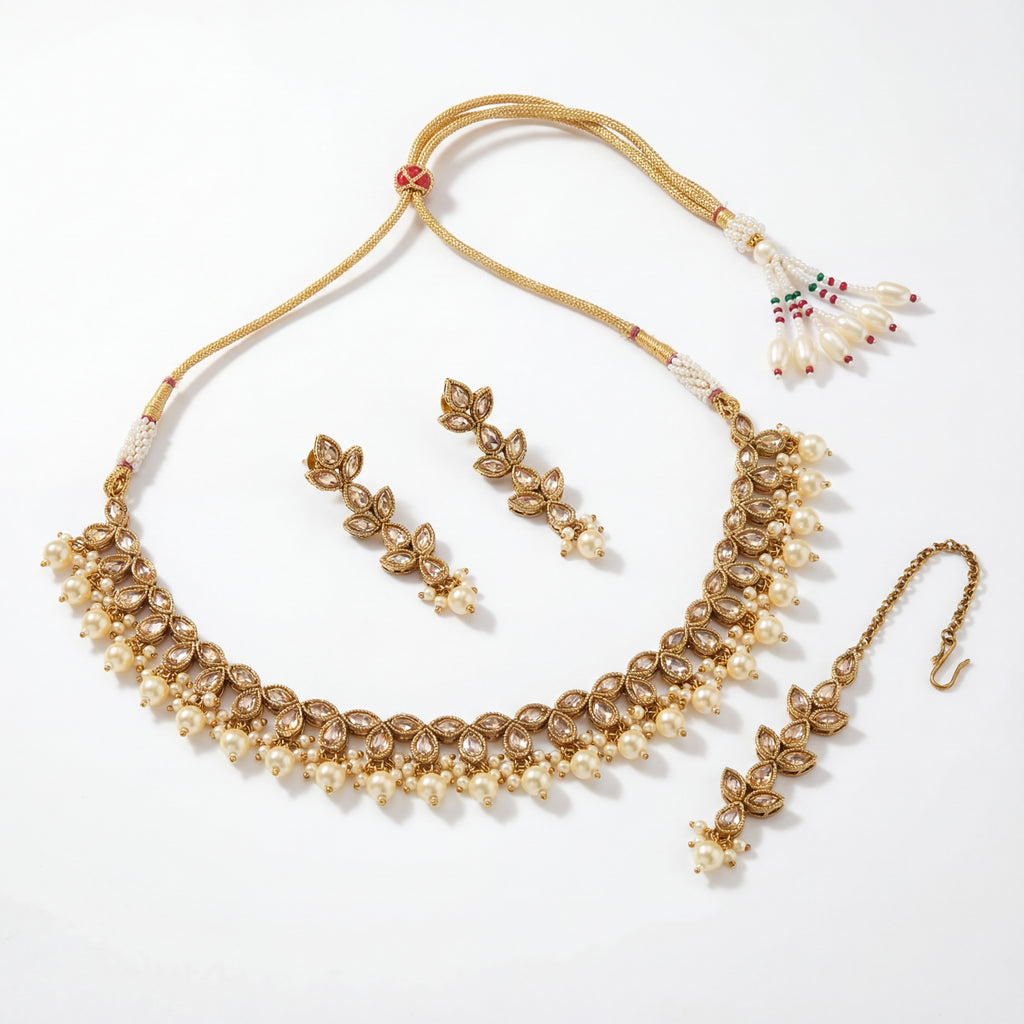Detail flatlay of the ivory pearl necklace set, highlighting the stonework and earrings.