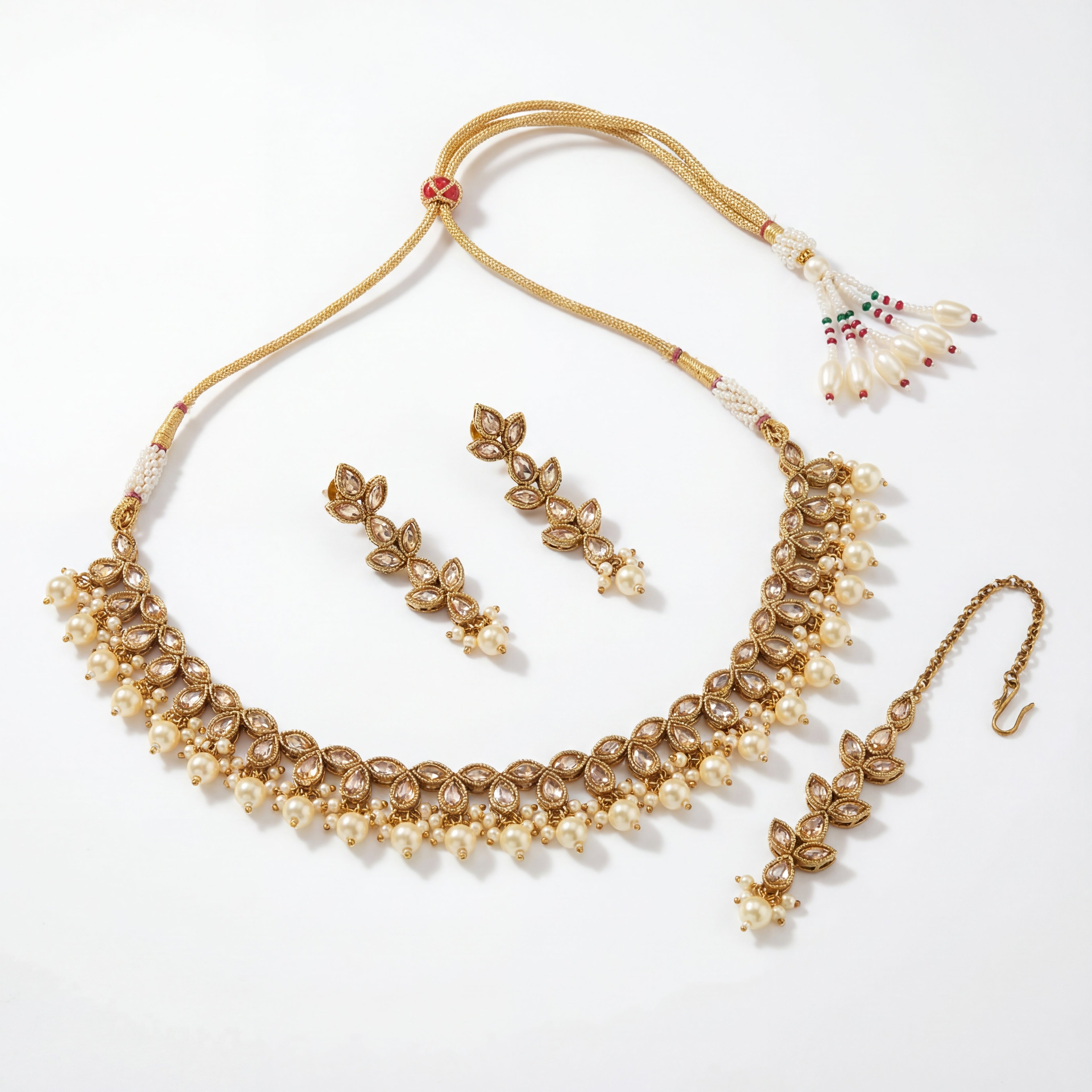 Detail flatlay of the ivory pearl necklace set, highlighting the stonework and earrings.