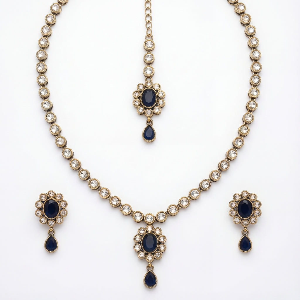 Studio flatlay of the silver-tone noir kundan necklace with matching earrings